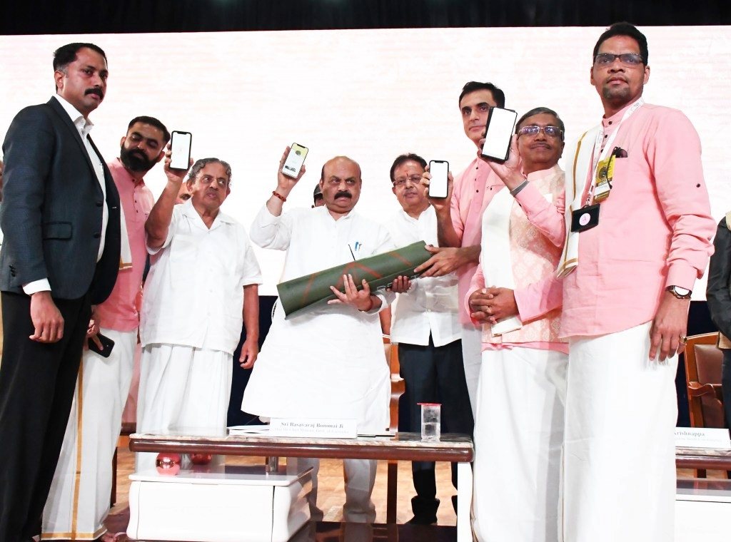 Launch event on stage with Karnataka Chief Minister Basavaraj Bommai, guests holding up phones